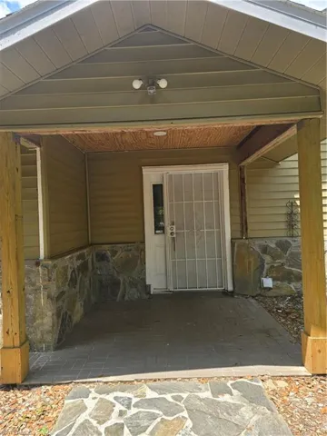 Property entrance with stone siding