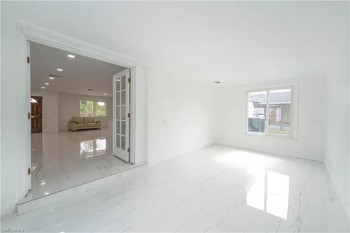 Unfurnished room with french doors