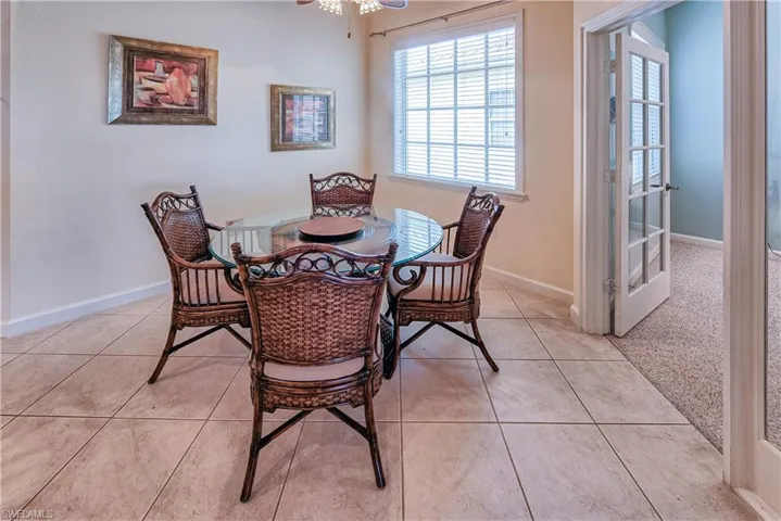 Dining space with baseboards and light tile patterned floors