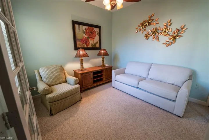 Sitting room with carpet floors and a ceiling fan