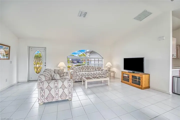 Living room with vaulted ceilings, professionally cleaned tile throughout