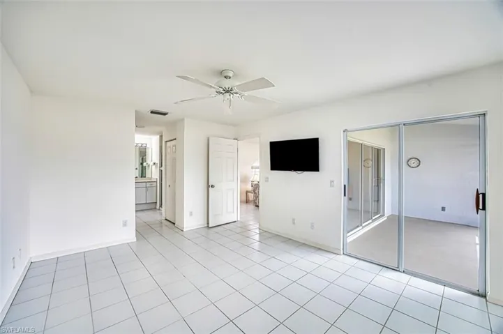 Spare room with baseboards, ceiling fan, and light tile patterned floors