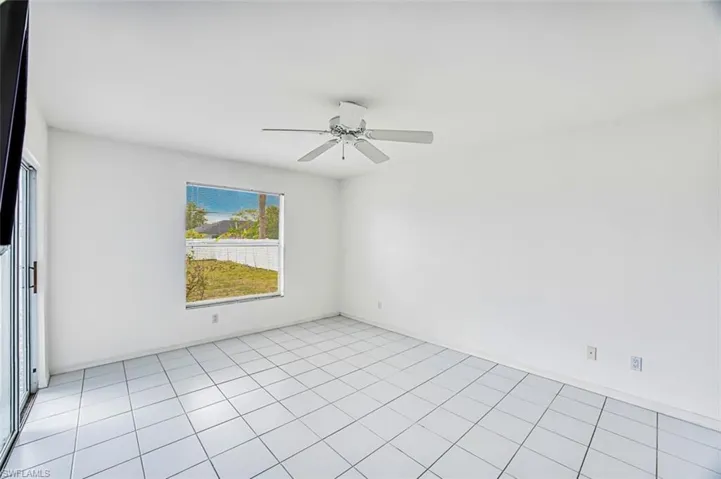 Primary bedroom with sliders that exit to lanai area