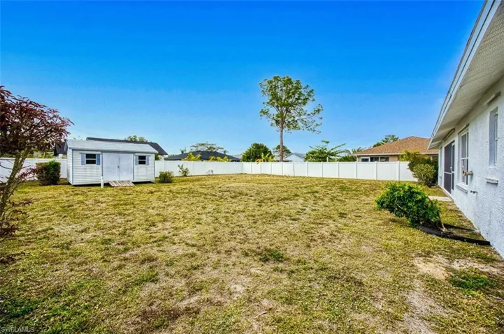 View of yard with a fenced backyardand a storage shed.  Plenty of room for a pool.