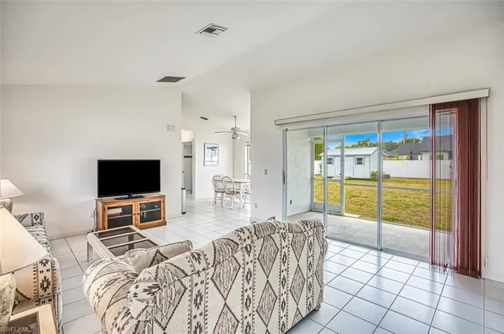Tiled living room with vaulted ceilings.  Fresh interior paint.