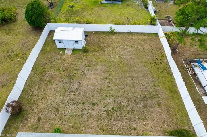 Large fenced in yard and a storage shed