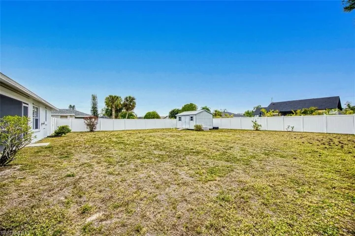 Fenced in oversized backyard with shed for storage