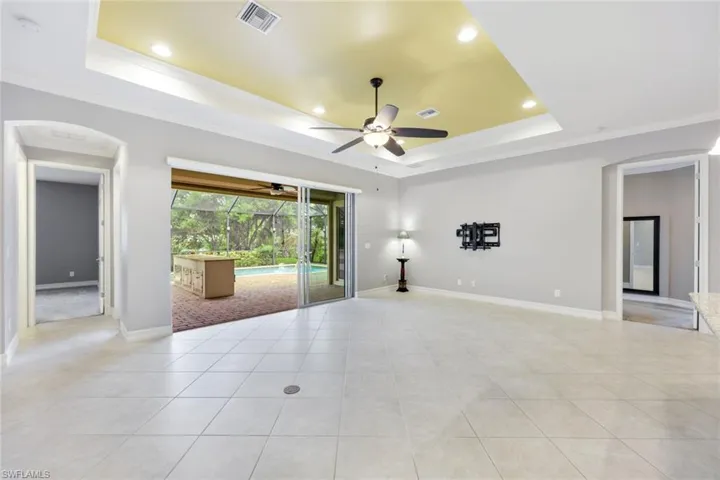 Large tiled living area with sliders that open to your beautiful pool area
