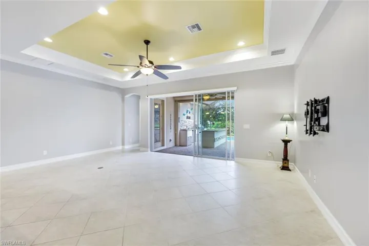 Large living area featuring a tray ceiling & diagonal set tile