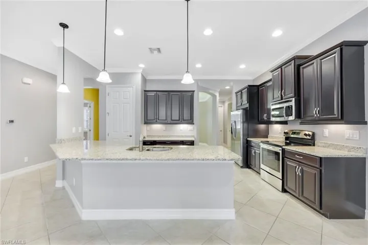 Large kitchen with wood cabinets & breakfast bar
