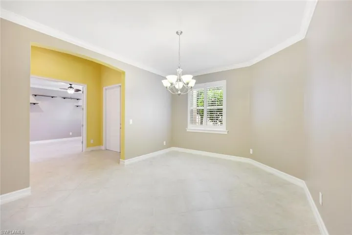 Formal dining room with crown molding and plantation shutters