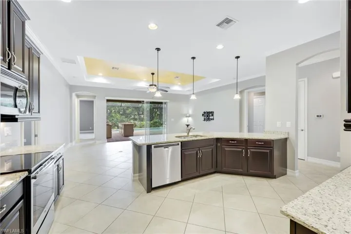 Gourmet kitchen with stainless steel appliances, wood cabinets & granite countertops