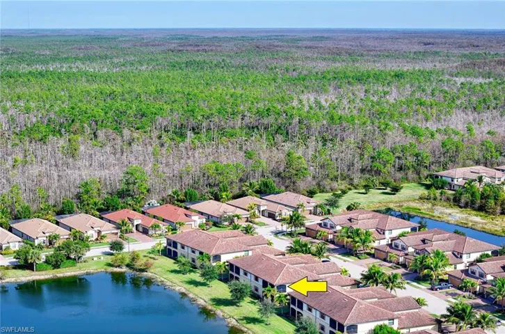 Aerial view of residential area featuring a nearby body of water