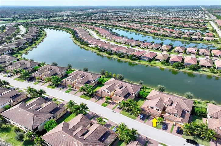 Aerial perspective of suburban area featuring a large body of water