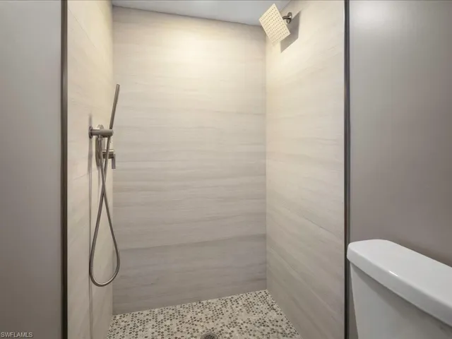 Bathroom featuring toilet and a tile shower