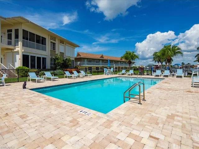 Community pool with a patio