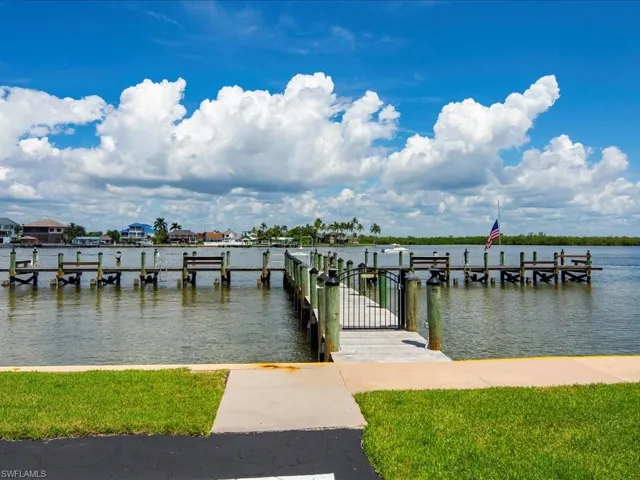Dock with a water view and a yard