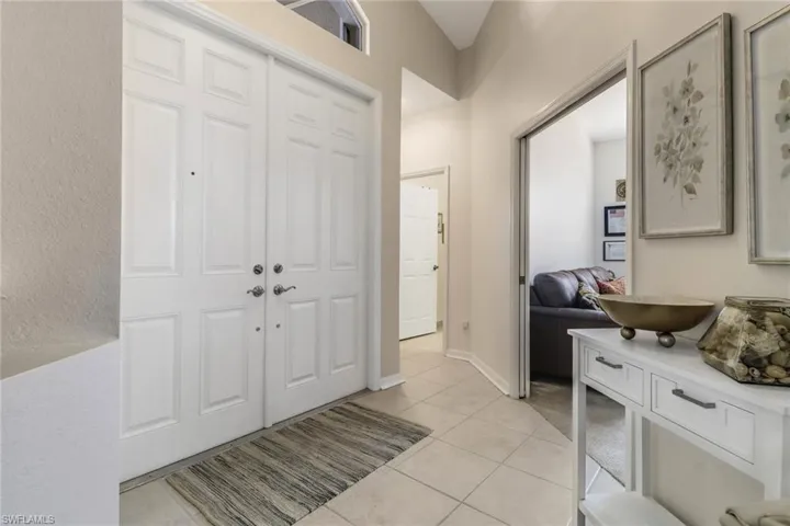 Entryway with light tile patterned floors