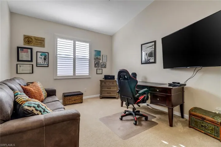 Home office featuring carpet flooring and baseboards