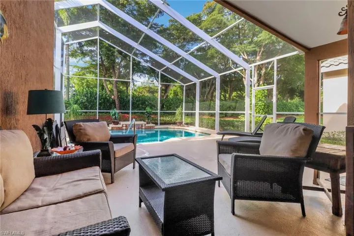 Outdoor pool with an outdoor living space, a patio, and glass enclosure