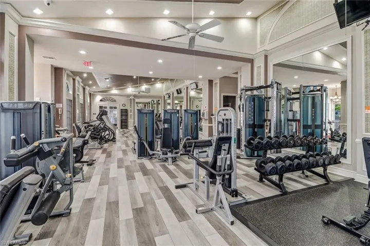 Gym featuring a ceiling fan and light wood-style floors