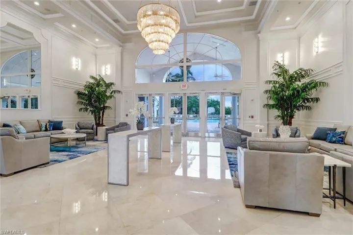 Lobby featuring a decorative wall, a high ceiling, and ornamental molding