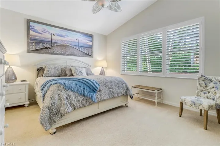 Bedroom featuring carpet flooring and vaulted ceiling