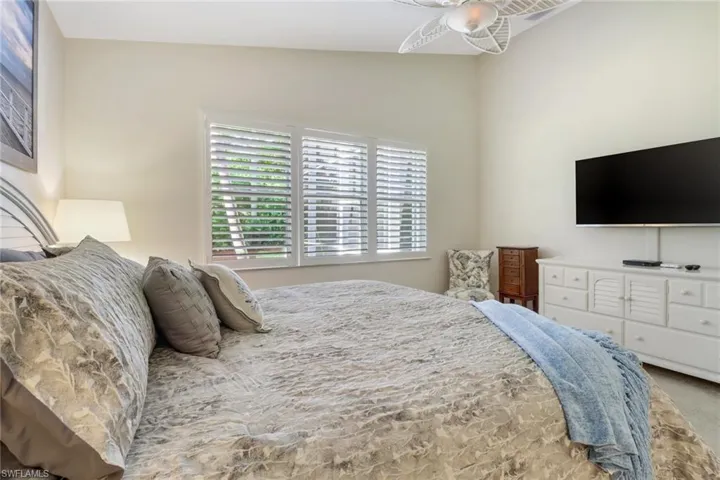 Carpeted bedroom featuring vaulted ceiling