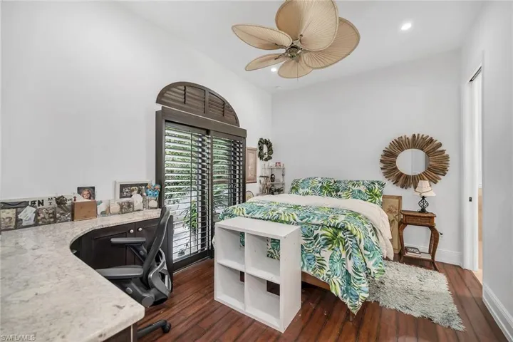 Bedroom featuring a desk, dark wood-type flooring, recessed lighting, and a ceiling fan