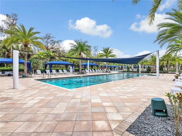 Community lap pool featuring a patio