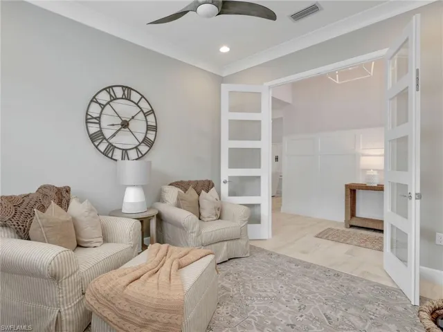 Beautiful French doors, ornamental molding, recessed lighting, a ceiling fan,