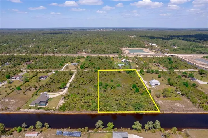 Bird's eye view with a water view and a wooded view