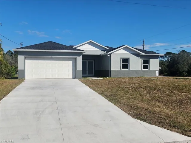 Single story home featuring french doors, a garage, and a front lawn