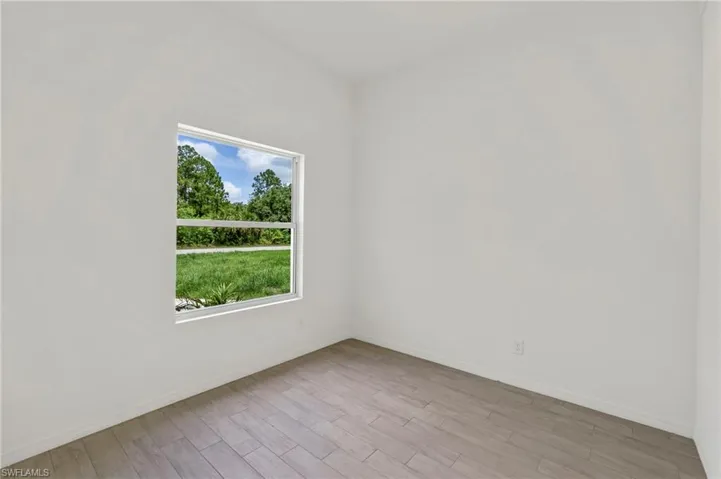 Spare room featuring wood-type flooring