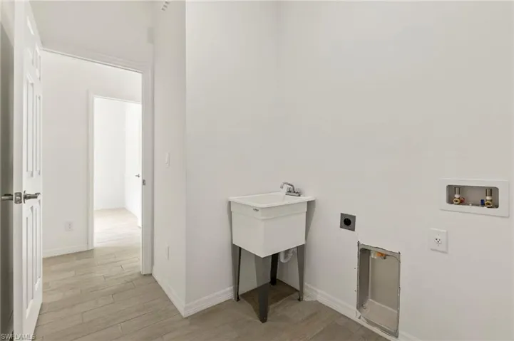 Laundry room with light hardwood / wood-style flooring, washer hookup, and electric dryer hookup