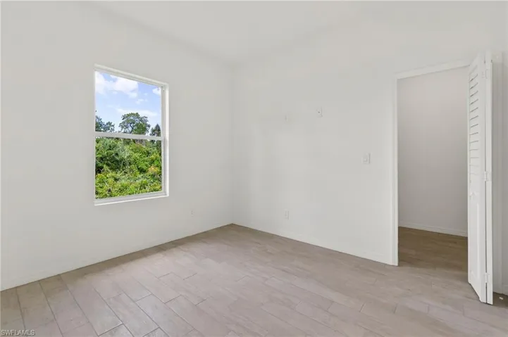 Empty room with light hardwood / wood-style floors
