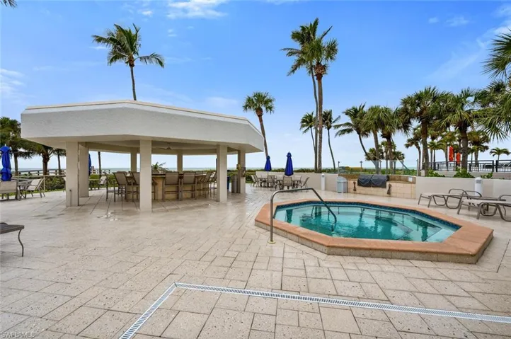 View of pool with a gazebo, a community hot tub, and a patio