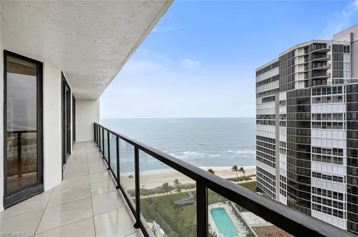 Balcony with a water view and a beach view
