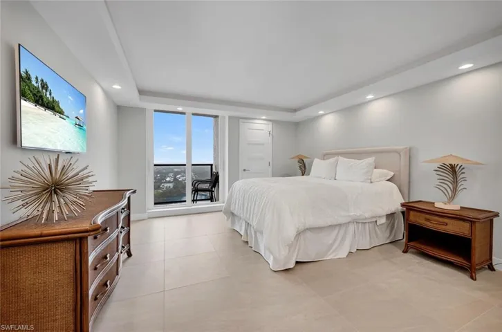 Tiled bedroom with a tray ceiling