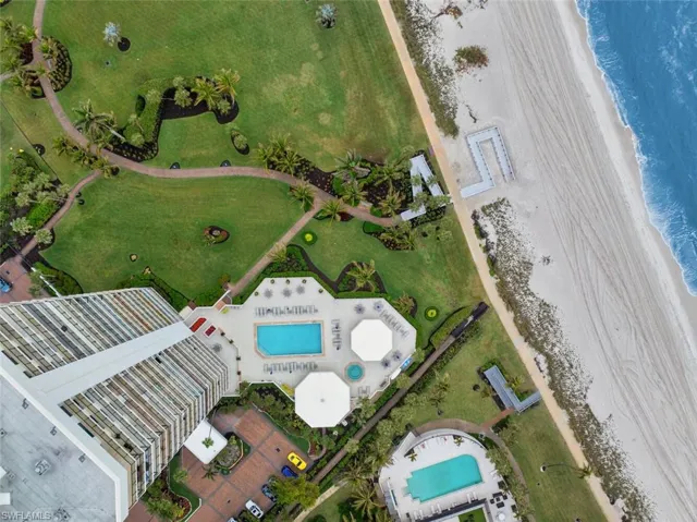 Drone / aerial view featuring a water view and a view of the beach