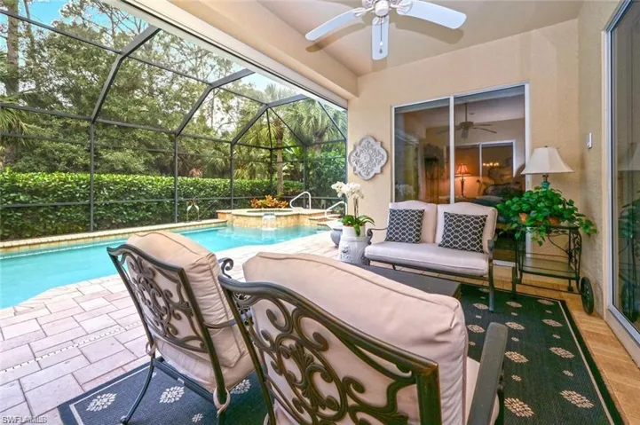 View of pool featuring an in ground hot tub, a patio, ceiling fan, and a lanai