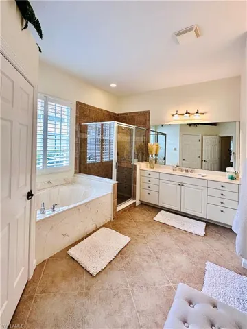 Bathroom with vanity, plus walk in shower, and tile patterned floors