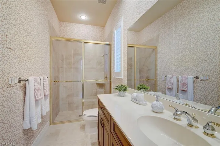 Ensuite #3 Full Bathroom featuring vanity, tile patterned flooring, toilet, and an enclosed shower