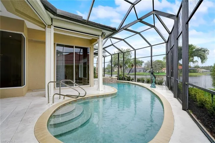View of swimming pool with a patio, a water view, and a lanai