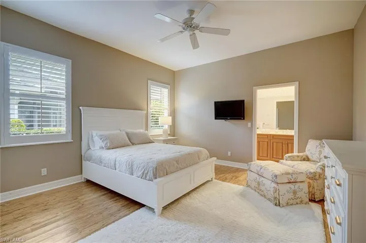 En Suite #3 Bedroom with multiple windows, light wood-type flooring, ceiling fan, and ensuite bathroom