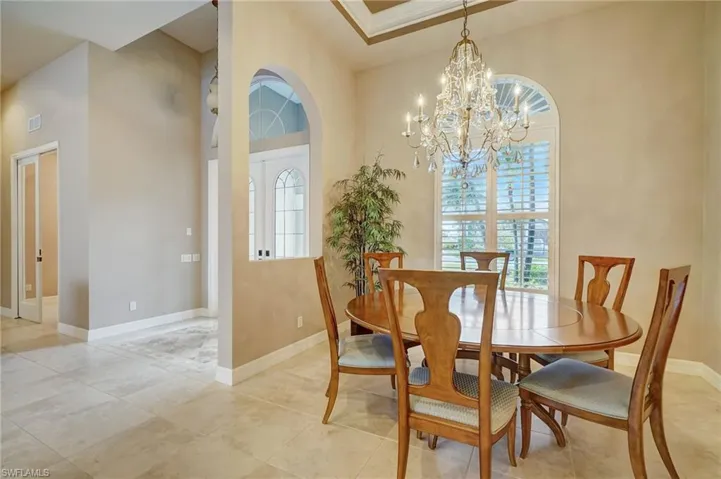Dining room with a towering ceiling and a chandelier