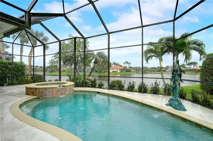 View of swimming pool featuring a water view and a lanai