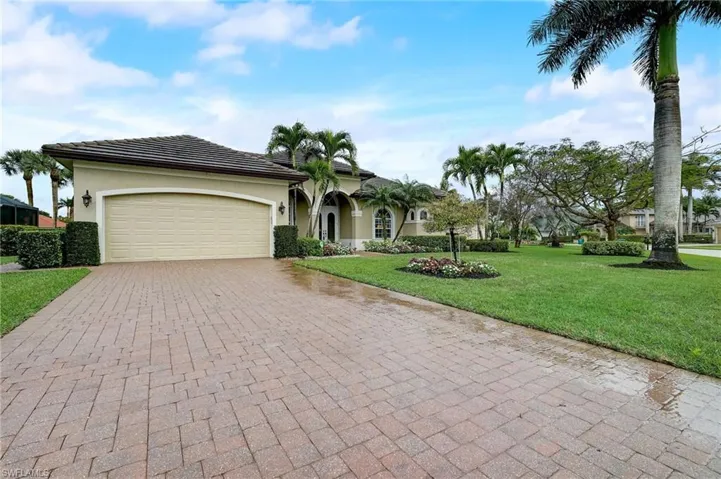 View of front of home featuring a garage lots of parking available and a front lawn