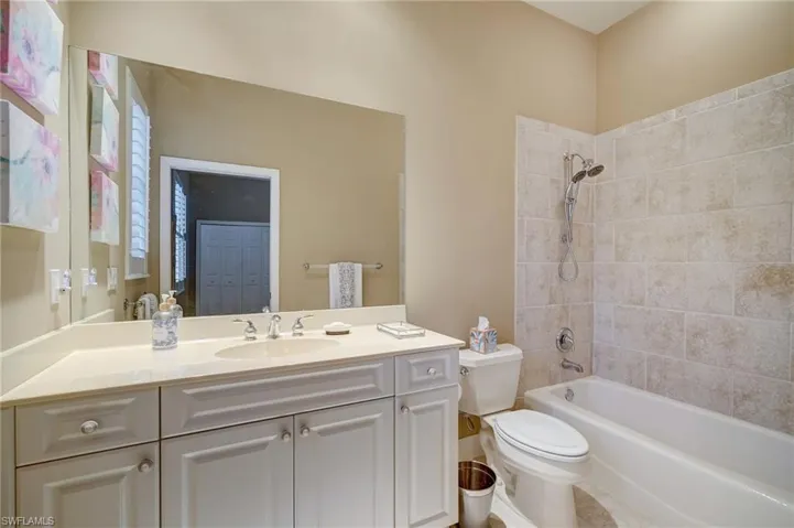 Ensuite #2 Full bathroom featuring tiled shower / bath, vanity, and toilet