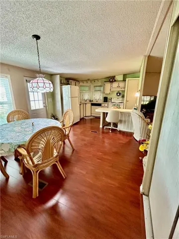 Dining space featuring hardwood / wood-style floors and a textured ceiling